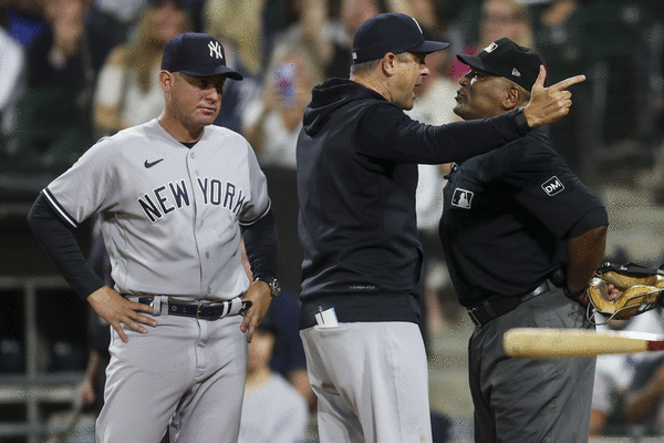 New York Yankees manager Aaron Boone imitates an umpire calling strike  three after arguing with home plate umpire Laz Diaz during the eighth  inning of a baseball game against the Chicago White