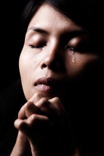 Woman praying. Dreamstime/TCA