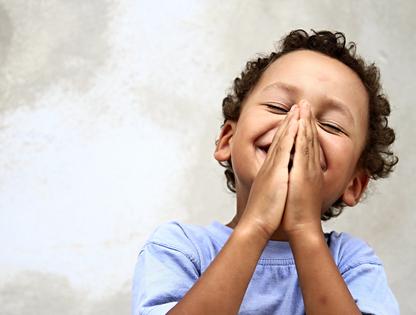 Little boy praying to God. Dreamstime/TCA