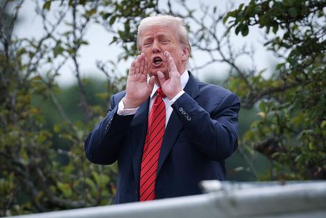 WASHINGTON, DC - AUGUST 05: U.S. President Donald Trump shouts answers to questions from reporters as he tours the roof of the West Wing of the White House on August 05, 2025 in Washington, DC. Trump has undertaken several renovation projects at the White House to include the construction of a concrete patio at the Rose Garden. (Photo by Win McNamee/Getty Images)