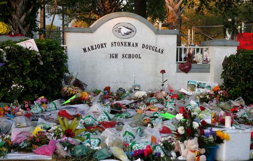 Flowers, candles and mementos sit outside one of the makeshift memorials at Marjory Stoneman Douglas High School in Parkland, Florida on February 27, 2018. Florida's Marjory Stoneman Douglas high school will reopen on February 28, 2018 two weeks after 17 people were killed in a shooting by former student, Nikolas Cruz, leaving 17 people dead and 15 injured on February 14, 2018. / AFP PHOTO / RHONA WISE        (Photo credit should read RHONA WISE/AFP via Getty Images)