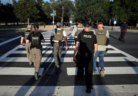 Federal law enforcement officers patrol on the National Mall on Aug. 12, 2025, in Washington, D.C. (Win McNamee/Getty Images/TNS)