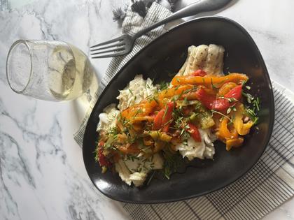 A saute of sweet peppers, tomatoes and onions over pan-seared cod hits the spot. (JeanMarie Brownson/TCA)