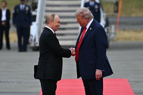 TOPSHOT - US President Donald Trump (R) greets Russian President Vladimir Putin on the tarmac after they arrived at Joint Base Elmendorf-Richardson in Anchorage, Alaska, on August 15, 2025. Putin is in Alaska at the invitation of Trump in his first visit to a Western country since he ordered the 2022 invasion of Ukraine that has killed tens of thousands of people. (Photo by ANDREW CABALLERO-REYNOLDS / AFP) (Photo by ANDREW CABALLERO-REYNOLDS/AFP via Getty Images)