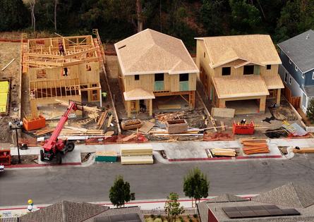 In an aerial view, construction workers build a home at a new housing development on July 1, 2025, in Hercules, California. According to a report by the U.S. Commerce Department's Census Bureau, U.S. construction spending fell 0.3% in May as higher mortgage rates and rising inventory impacted single-family housing projects. (Justin Sullivan/Getty Images/TNS)