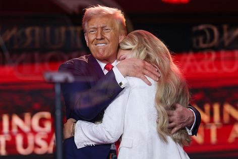 GLENDALE, ARIZONA - SEPTEMBER 21:  Erika Kirk joins U.S. President Donald Trump onstage during the memorial service for political activist Charlie Kirk at State Farm Stadium on September 21, 2025 in Glendale, Arizona. Kirk, the CEO and co-founder of Turning Point USA, was shot and killed on September 10th while speaking at an event during his 