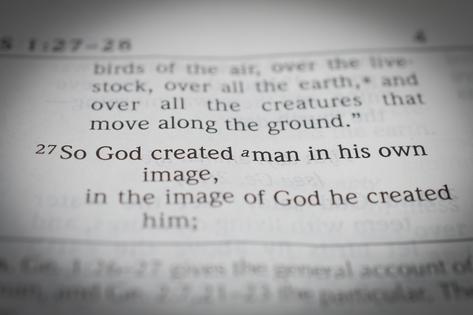 Black and white macro photo of one the most famous bible verses: Genesis 1:27 So God created man in his own image. Dreamstiome/TCA