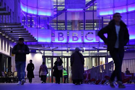 People use the entrance to the offices of British broadcaster BBC in London in the late afternoon on November 11, 2025. The BBC's outgoing boss urged staff to 