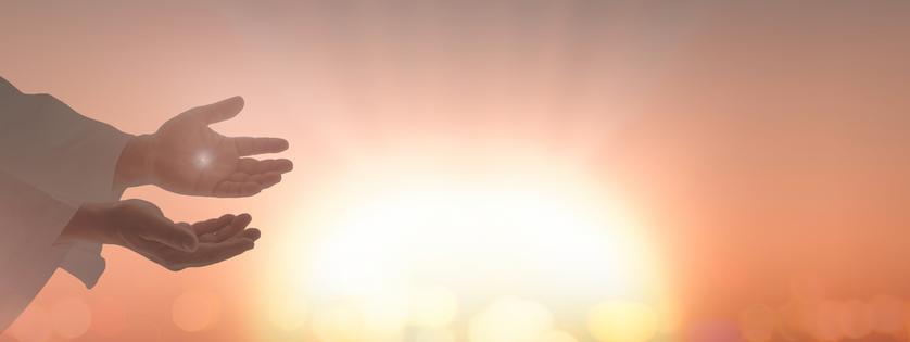 Jesus Christ hands showing scars for Thomas over blurred cross sunset background. Dreamstime/TCA