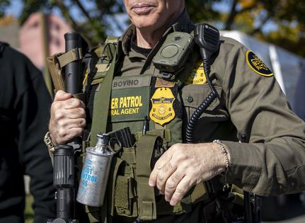 U.S. Border Patrol Cmdr. Gregory Bovino carries tear gas, a rifle and a body camera while conducting immigration enforcement operations on Oct. 31, 2025, in Chicago’s Edison Park neighborhood. (Brian Cassella/Chicago Tribune/TNS)