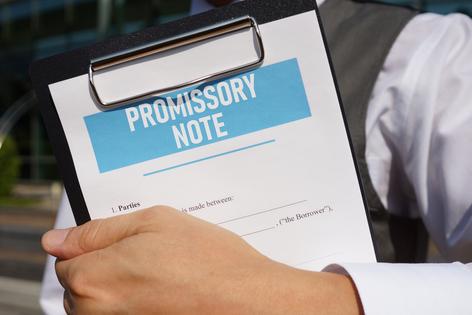A promissory note spells out the terms of the loan. (Dreamstime/TCA)