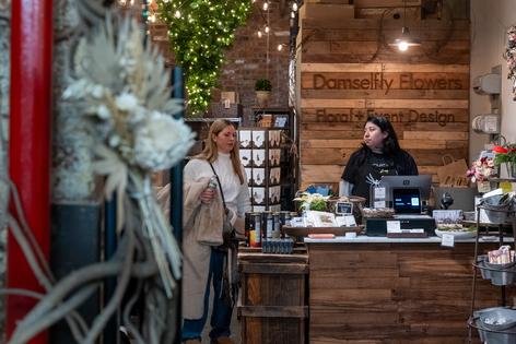 A woman works in a flower store in Manhattan on Tuesday, Dec. 16, 2025, in New York City. The Bureau of Labor Statistics reported that the U.S. economy lost 105,000 jobs in October and added 64,000 jobs in November, resulting in a four-year high unemployment rate of 4.6 percent in November. (Spencer Platt/Getty Images/Tribune Content Agency)