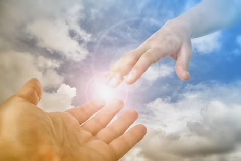 God Hand reaching for the faithful. Dreamstime/TCA