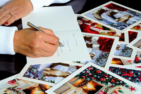 Writing out Christmas cards. Dreamstime/TCA