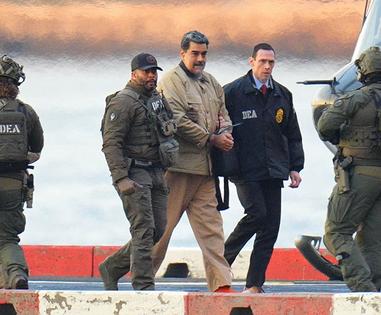 Nicolas Maduro in handcuffs after landing at a Manhattan helipad, escorted by heavily armed Federal agents as he and his wife make their way into an armored car en route to a Federal courthouse in Manhattan on Jan. 5, 2026, in New York City. (Starmax/Newscom via ZUMA Press/TNS)