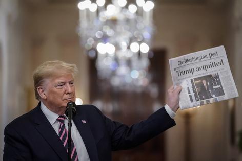 In this photo from Feb. 6, 2020, U.S. President Donald Trump holds a copy of The Washington Post as he speaks in the East Room of the White House one day after the U.S. Senate acquitted on two articles of impeachment in Washington, D.C. (Drew Angerer/Getty Images/TNS)