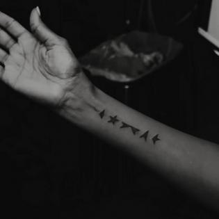 Bang Showbiz / Iman has the five minimalist rune-like black shapes from the bottom of David Bowie's final album, Blackstar, tattooed on her forearm/ © Instagram.