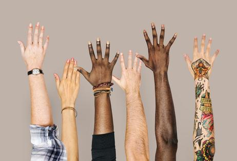 Diversity hands raised up gesture. Dreamstime/TCA