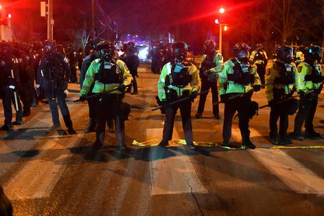 State troopers form a line in the street in Minneapolis, Minnesota, on Jan. 14, 2026, after protesters clashed with federal law enforcement following the shooting of a Venezuelan man by a Immigration and Customs Enforcement (ICE) agent. (Octavio JONES/AFP via Getty Images/TCA)