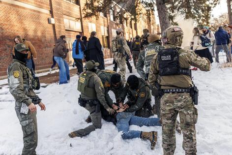 U.S. Border Patrol agents detain a person near Roosevelt High School during dismissal time as federal immigration enforcement actions sparked protests in Minneapolis on Jan. 7, 2026. (Kerem Yucel/AFP/Getty Images/TNS)