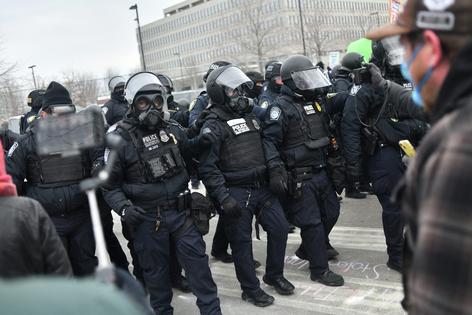 Federal law enforcement agents confront anti-ICE protesters outside the Bishop Whipple Federal Building in Minneapolis on Jan. 15, 2026.
              Octavio Jones/AFP via Getty Images