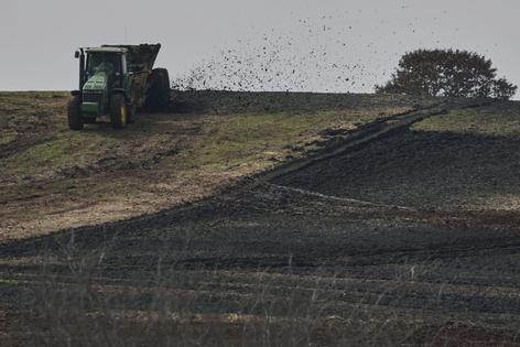 A spreader sprays sewage sludge, which is rich in phosphorus, across a farm in Oklahoma. AP Photo/Joshua A. Bickel