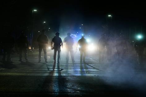 Federal immigration officers are seen outside the Bishop Whipple Federal Building in Minneapolis on Jan. 12, 2026. AP Photo/Jen Golbeck