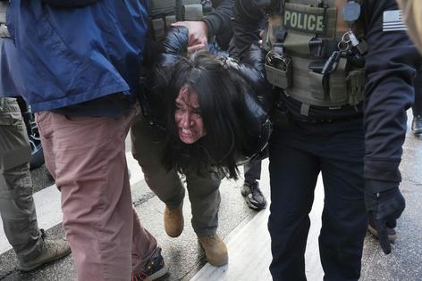 A woman is detained by federal agents in Minneapolis on Jan. 13, 2026.
              AP Photo/Adam Gray