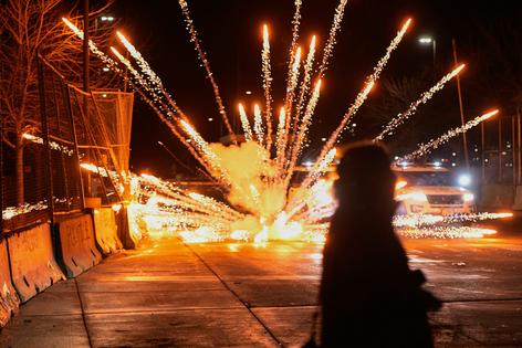 Fireworks are set off by protesters outside the Bishop Henry Whipple Federal Building in Minneapolis on Jan. 12, 2026.
              AP Photo/Jen Golbeck