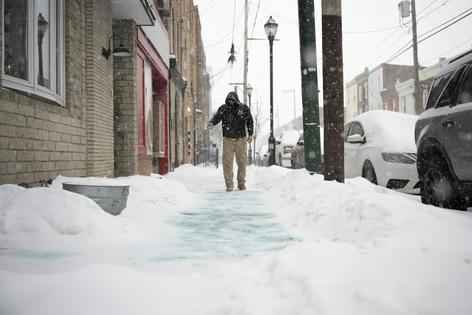 Conservation organizations recommend using one 12-ounce coffee mug of deicer for every 10 sidewalk squares. Joe Lamberti/Getty Images News via Getty Images