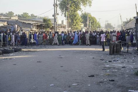 Residents gather near the scene of the explosion at a mosque in the Gamboru market in Maiduguri on Dec. 25, 2025.
              Audu Marte/AFP via Getty Images