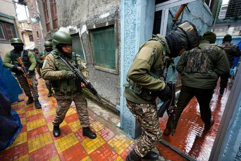 Indian paramilitary personnel conduct a house-to-house search in Kashmir.
AP Photo/Mukhtar Khan