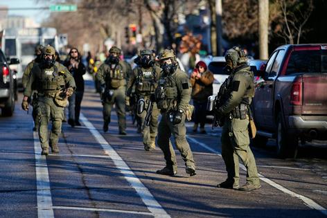 ICE agents on patrol near the scene of the fatal shooting of Renee Good in Minneapolis.
              AP Photo/John Locher