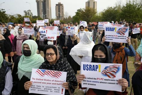 Afghan refugees hold placards during a protest in Islamabad, Pakistan, on Feb. 26, 2023. AP Photo/Rahmat Gul