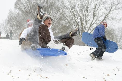 Playing in the snow, like this group was at Cherokee Park in Louisville, Ky., can be the best part of winter, but be sure to do it safely. At least three people died in accidents while being towed on sleds behind vehicles on icy streets during the January 2026 storm.
              Jon Cherry/Getty Images