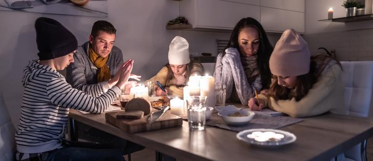Wearing knit caps, lots of layers and staying together in one room can help with warmth. If you light candles, use them carefully to avoid fires.
SimpleImages/Moment via Getty Images