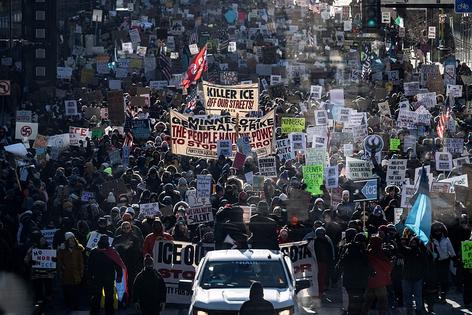TOPSHOT - Protesters against Immigration and Customs Enforcement (ICE) march through the streets of downtown Minneapolis, Minnesota, on January 25, 2026. On January 24, federal agents shot dead US citizen Alex Pretti, a 37-year-old ICU nurse, while scuffling with him on an icy roadway, less than three weeks after an immigration officer shot and killed Renee Good, also 37, in her car. His killing sparked new protests and impassioned demands by local leaders for the Trump administration to end its operation in the city. (Photo by ROBERTO SCHMIDT / AFP via Getty Images)