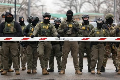 U.S. Border Patrol agents stand guard at the Bishop Henry Whipple Federal Building in Minneapolis, Minn., on Jan. 8, 2026. Charly Triballeau/AFP via Getty Images