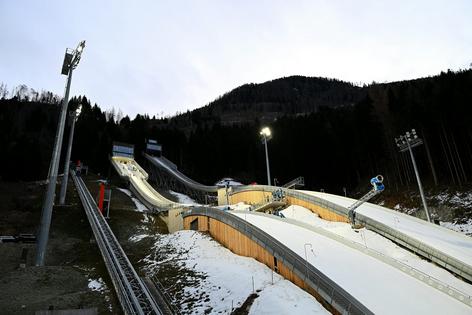 Italy's Predazzo Ski Jumping Stadium, which is hosting events for the 2026 Winter Olympics, needed snowmaking machines for the Italian National Championship Open on Dec. 23, 2025. Mattia Ozbot/Getty Images