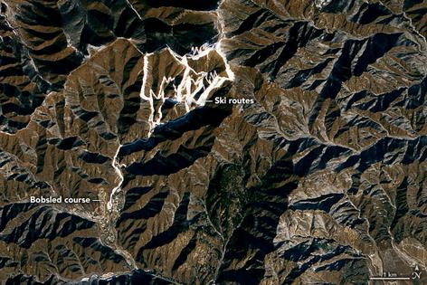 A satellite view clearly shows the absence of natural snow during the 2022 Winter Olympics. Beijing’s bid to host the Winter Games had explained how extensively it would rely on snowmaking.
              Joshua Stevens/NASA Earth Observatory