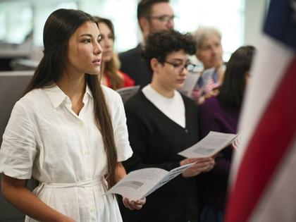A small group of individuals prepare to take the naturalization oath to become U.S. citizens.
O2O Creative via Getty Images