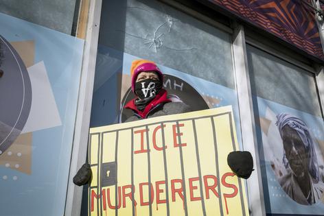 Sue, a woman who came to Minneapolis from Chicago to join the anti ICE protests carries a poster past window panels showing two gun perforations on Jan. 26, 2026, that according to the business owner said were made when Alex Pretti was gunned down by federal agents in Minneapolis on Jan. 24, 2026. A makeshift memorial at the shooting scene has been the center of attention for well wishers. A makeshift memorial at the shooting scene has been the center of attention for well wishers. On Jan. 24, federal agents shot and killed Alex Pretti, a 37-year-old ICU nurse, while scuffling with him on an icy roadway in Minneapolis, less than three weeks after an immigration officer fired on Renee Good, also 37, killing her in her car. U.S. President Donald Trump blamed their deaths on Democratic 