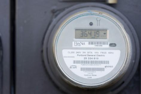 A meter keeps track of how much electricity customers use – but the price is a separate question.
              AP Photo/Jenny Kane