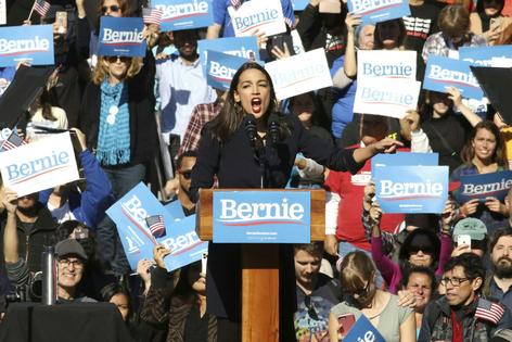 New York Democratic Rep. Alexandria Ocasio-Cortez exhorts the crowd at a 2019 Bernie Sanders presidential campaign rally in Long Island City, N.Y.
              Invision/Greg Allen via AP