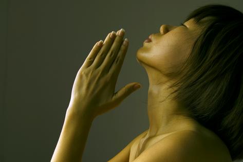 Woman praying. Dreamstime/TCA