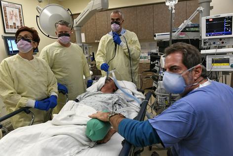 Health care often involves teams whose members play varying roles. Here, Dr. Akrum Al-Zubaidi performs a bronchoscopy on patient Orlando Carrasco, with the help of his team, from left, Ana Stefan, R.N., Mike Galloway, respiratory therapist, and anesthesiologist Michael Kessler, M.D., on Aug. 7, 2017, at National Jewish Health in Denver, Colo.
Helen H. Richardson/The Denver Post via Getty Images