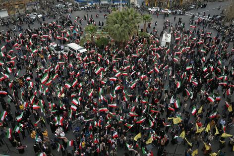 A group of demonstrators in Tehran wave Iranian flags in support of the government on Feb. 28, 2026 AP Photo/Vahid Salemi