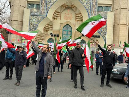 A group of men wave Iranian flags as they protest U.S. and Israeli strikes in Tehran, Iran, on Feb. 28, 2026.
              AP Photo/Vahid Salemi