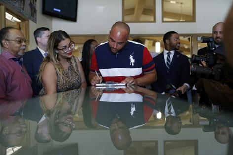 Javon Jackson, center, was able to register to vote following passage of a 2019 Nevada law that restored voting rights to formerly incarcerated individuals. AP Photo/John Locher
