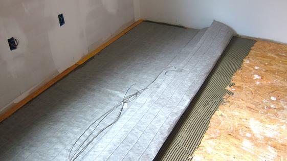 This is one way to add extra heat to your home. This gray mat contains electrical heating cables that make the floor toasty warm sans crumbs! (Tim Carter/Tribune Content Agency/TNS)